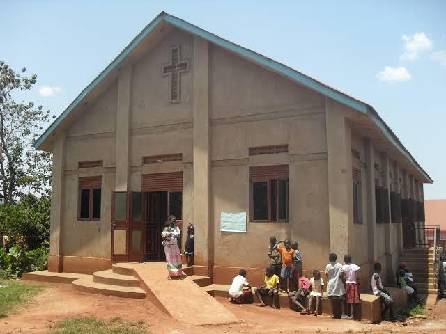 Completed church building in Uganda with community members